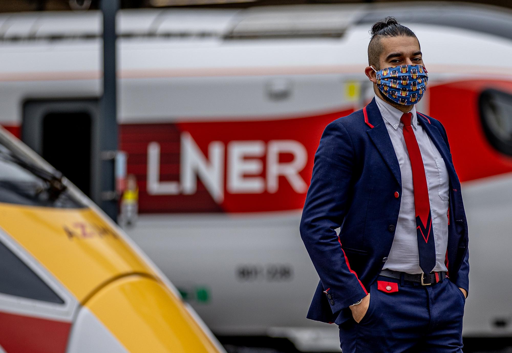 LNER Station Support Assistant Emrah Mehmet wearing the LNER Azuma Mask at London King’s Cross Station.