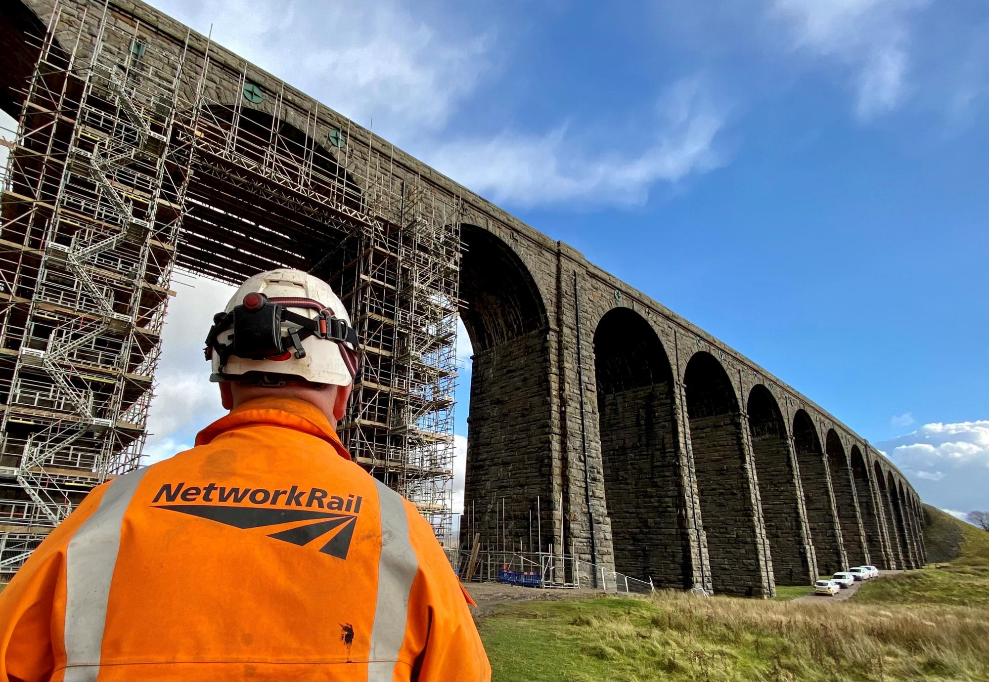 Ribblehead viaduct with a Network Rail worker in the foreground