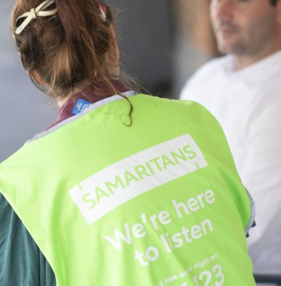 Samaritans volunteer speaking with a male 