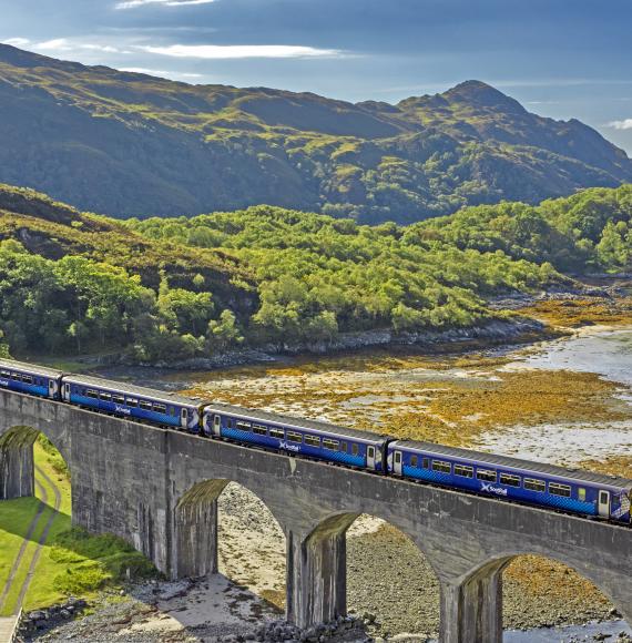 Scotrail train passing over the eight arch Nan Uamh Viaduct in late summer, via Istock 