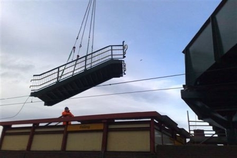 New bridge lifted into place over rail lines