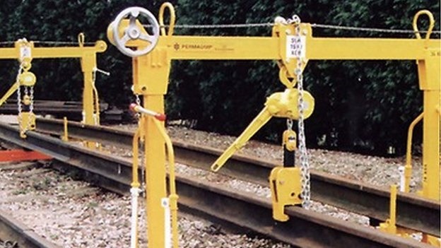 Rail workers narrowly avoid injury as iron-man breaks free