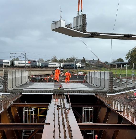 Old bridge from new Clifton bridge with M6 and Avanti train in the background