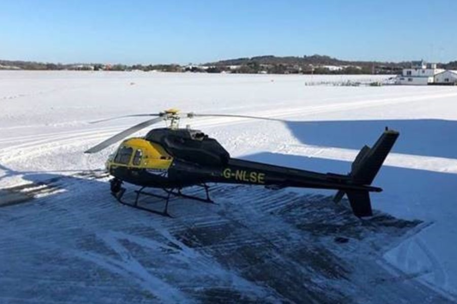 Network Rail helicopter preparing for take off in the snow