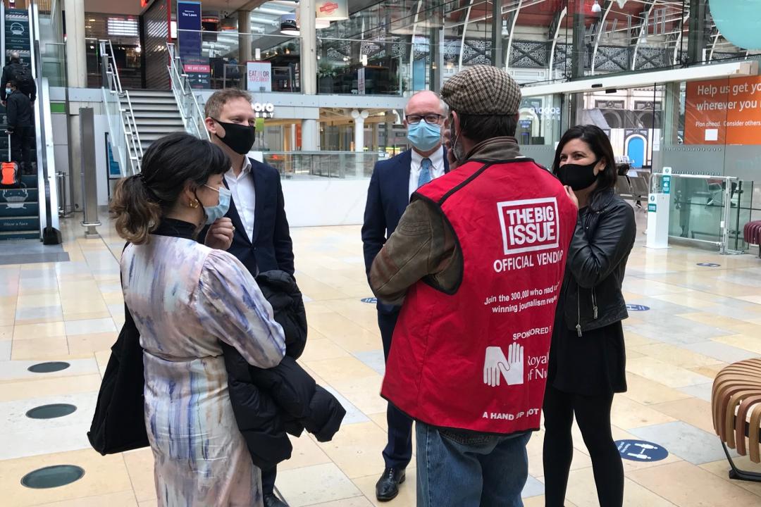 Grant Shapps and Andrew Haines speaking with Big Issue vendor and artist John Cahill, who will paint a mural at Paddington 