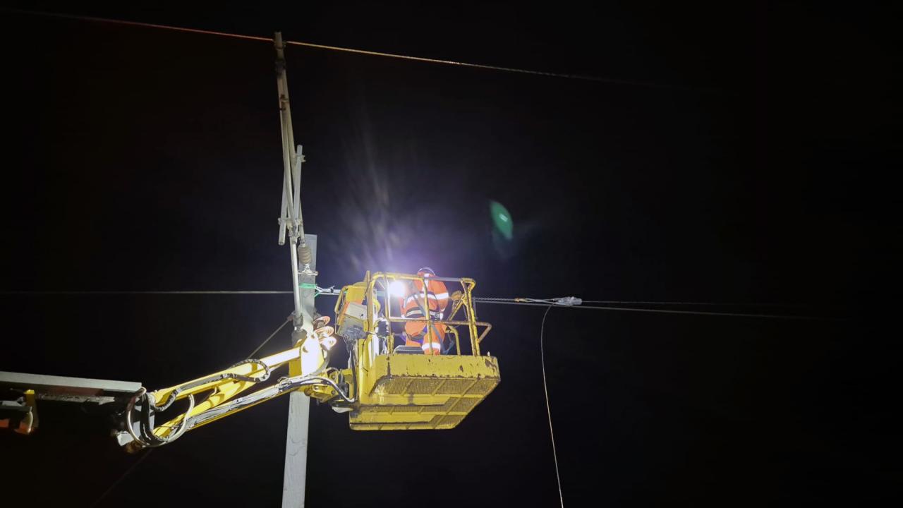Teams working on overhead lines in Lancashire by night 