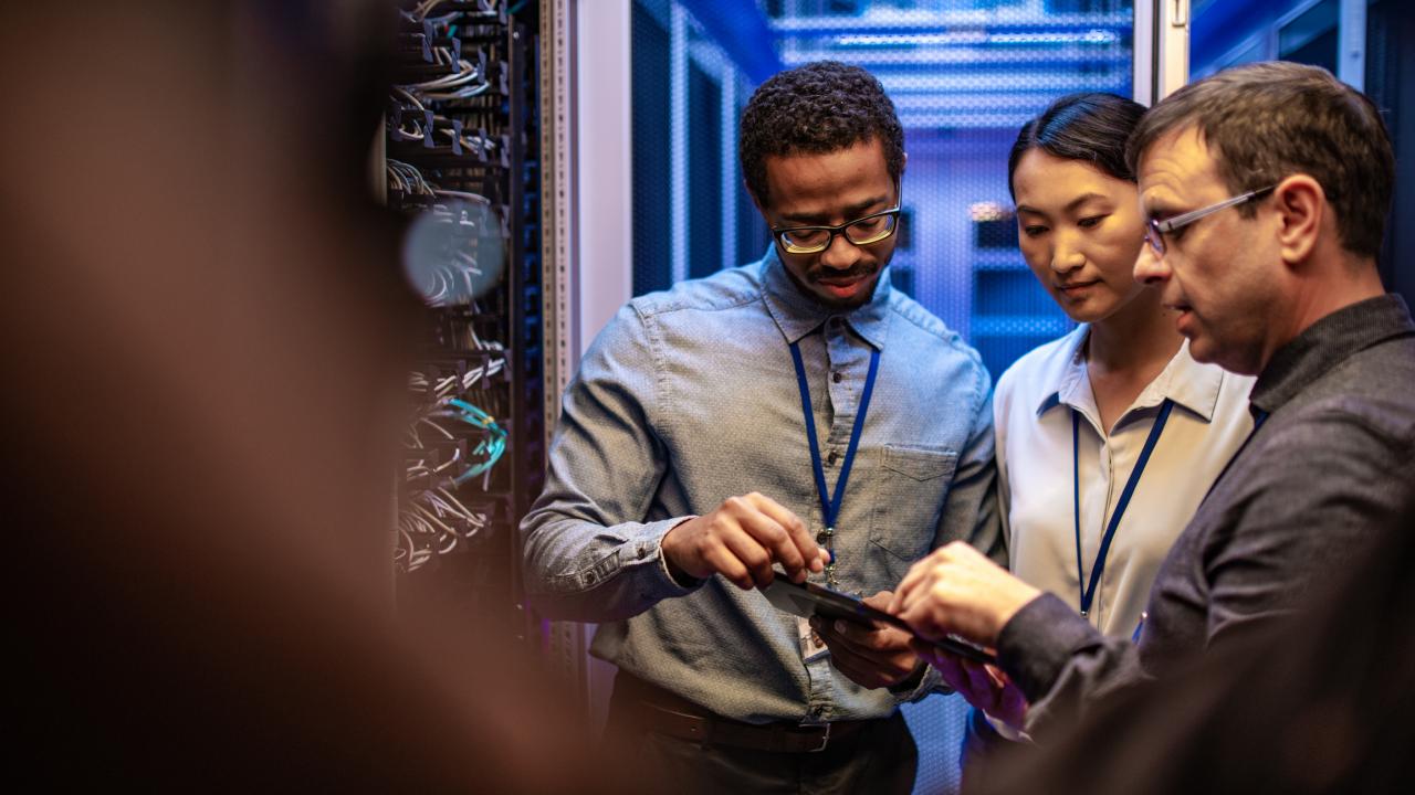 IT workers in a server room problem solving