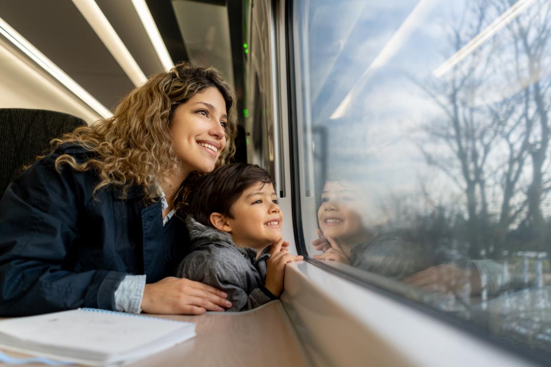 Mother and son watching out of a train window