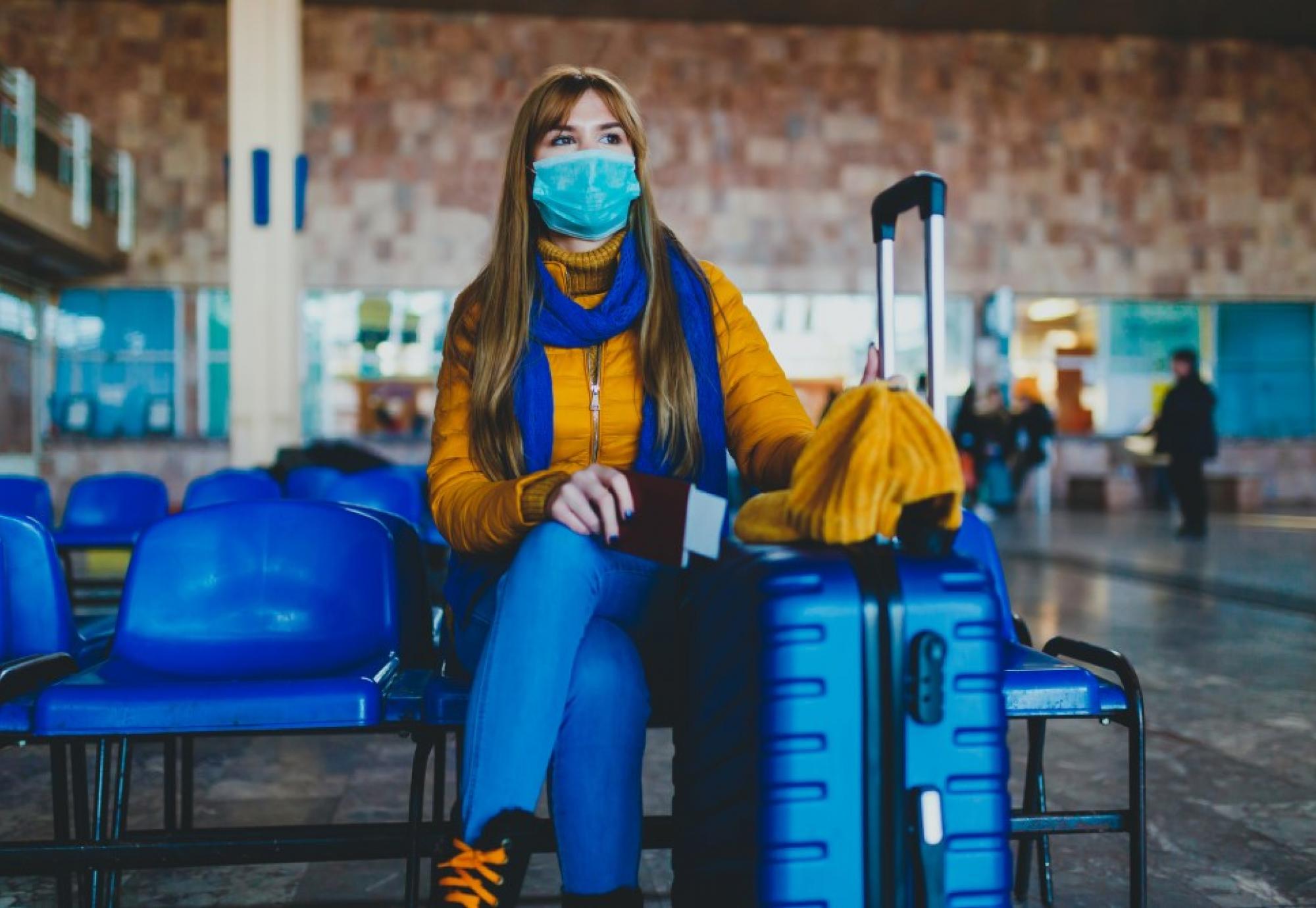 Woman at station waiting for missed or cancelled transport due to a coronavirus