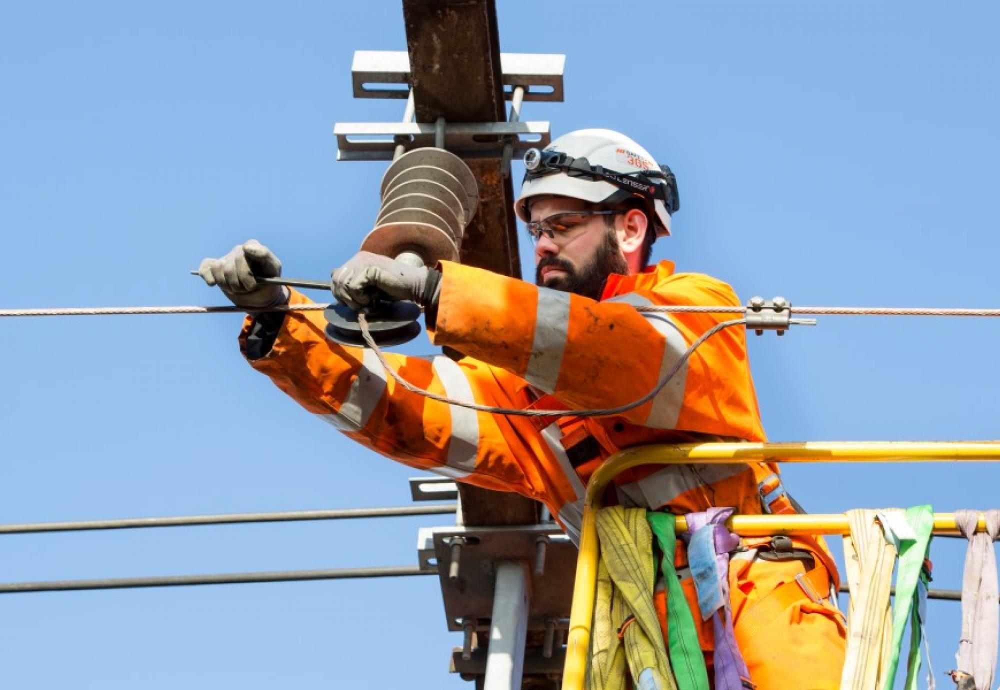 Man doing overhead line equipment work 