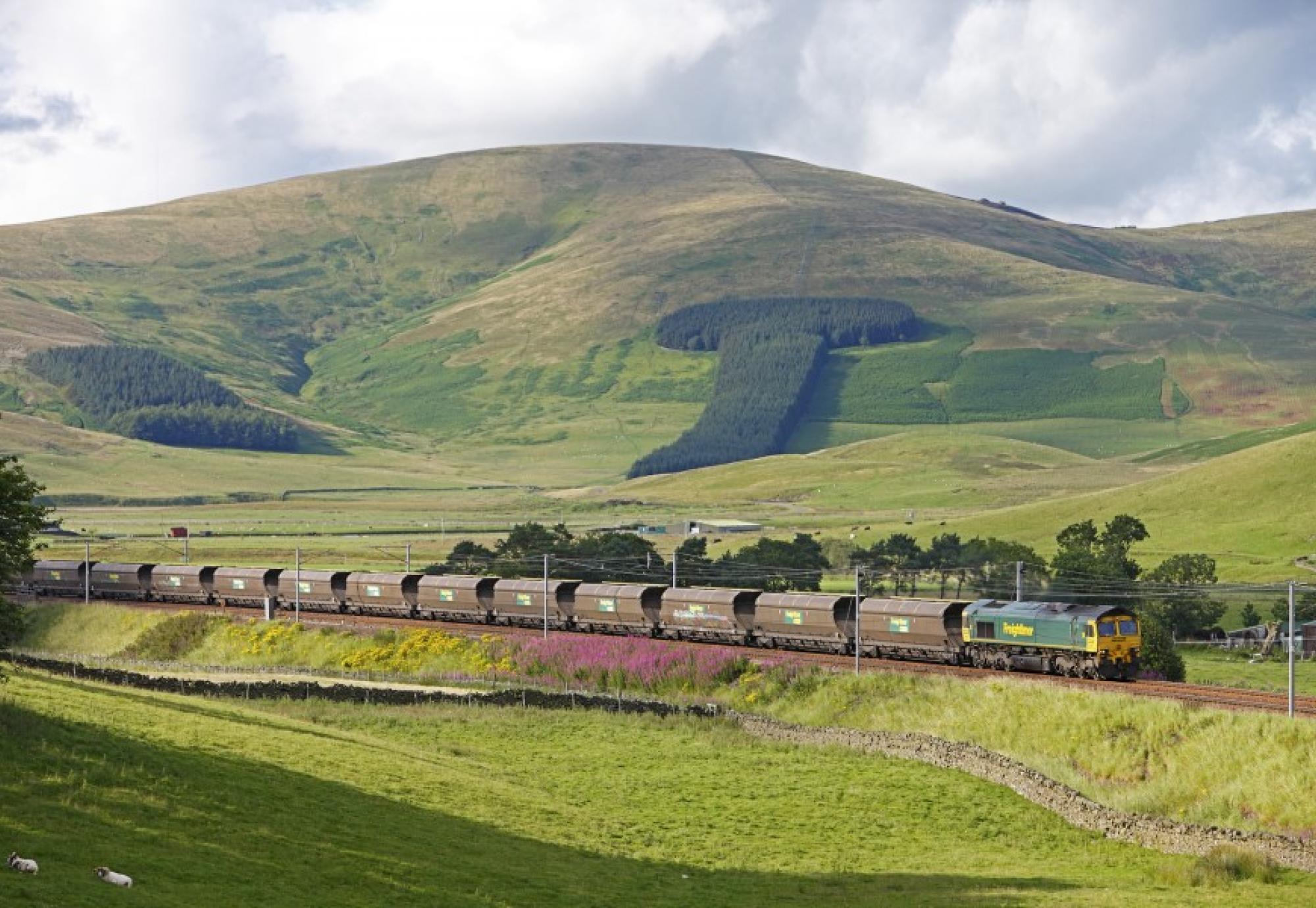 reightliner Heavy Haul coal train as it passes through scenic Scottish countryside.