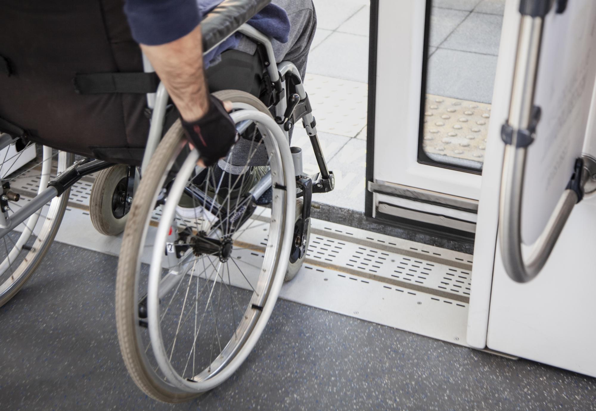 Passenger in a wheelchair disembarking from a train