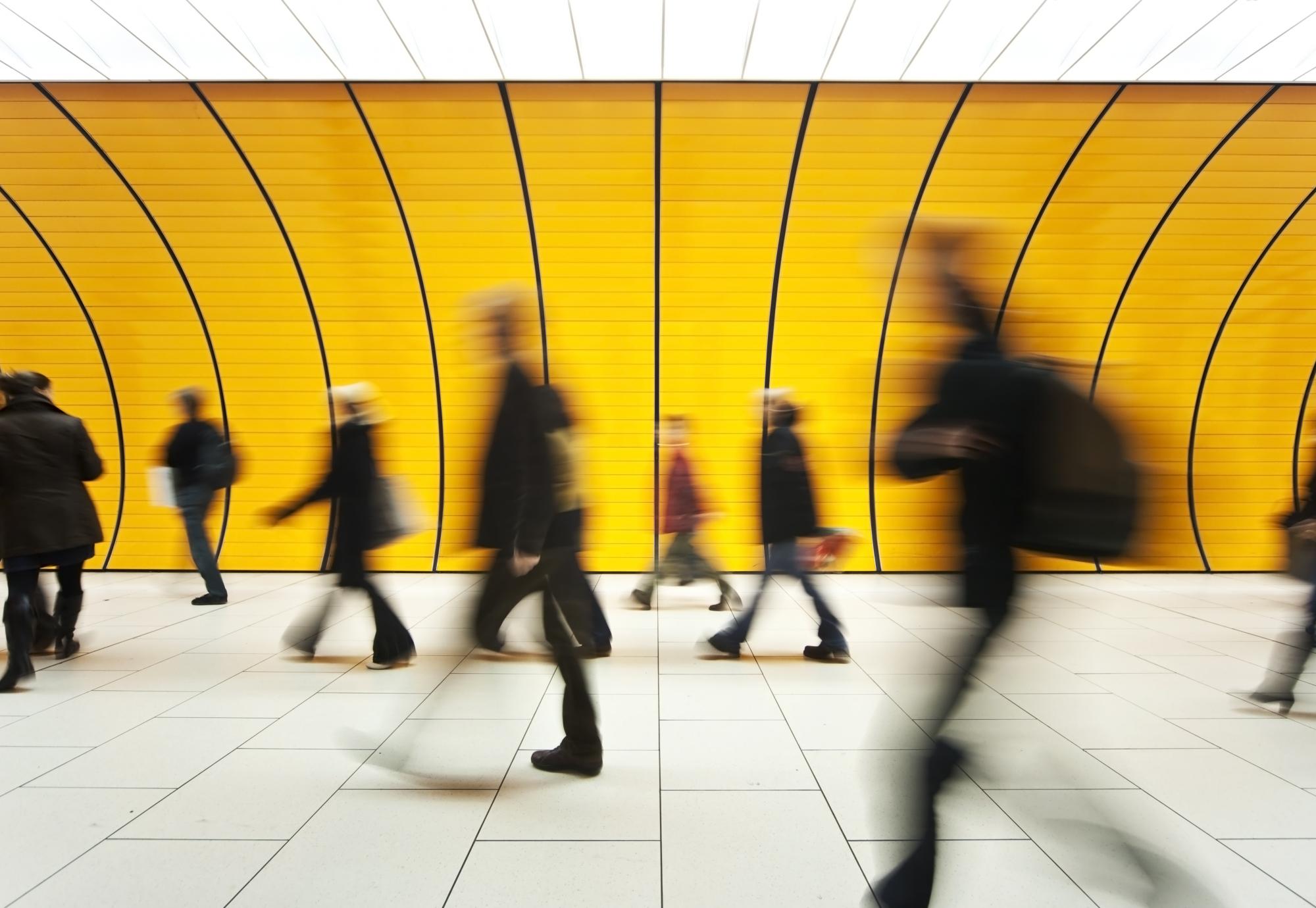 Commuters wlaking past on a train platform