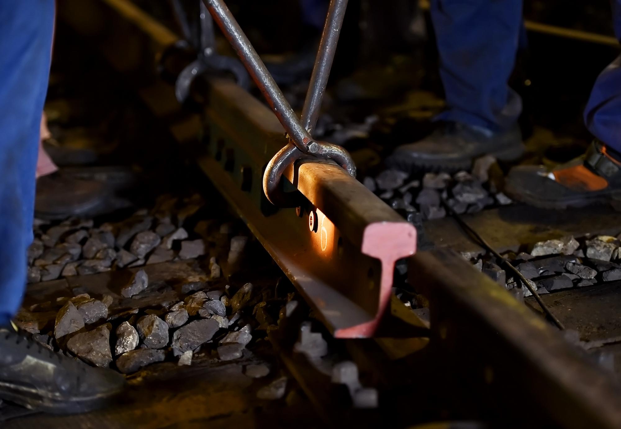 Rail workers laying a section of track