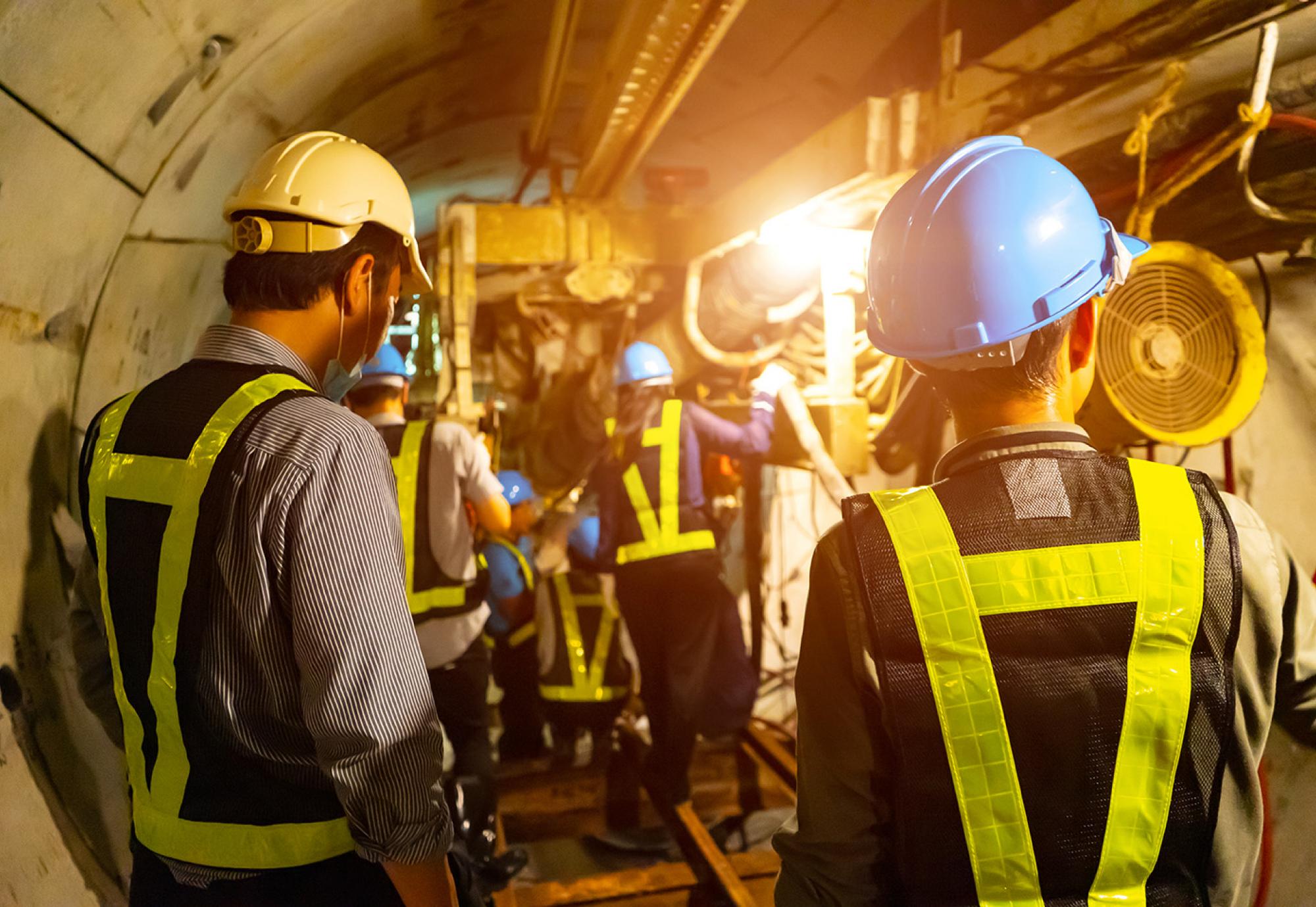 Engineers in a tunnel performing maintenance