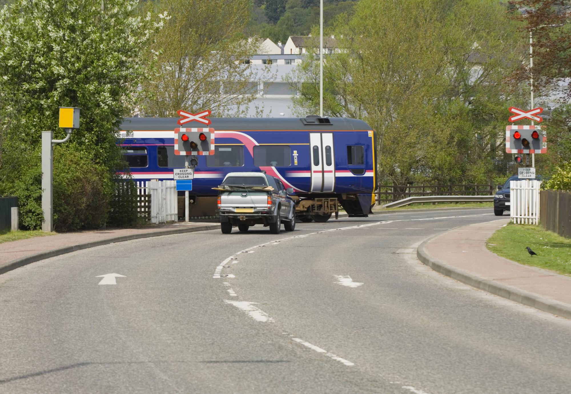 Train crossing a road at a level crossing