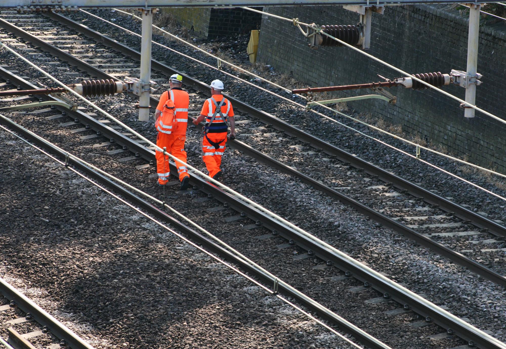 Two rail workers on the track