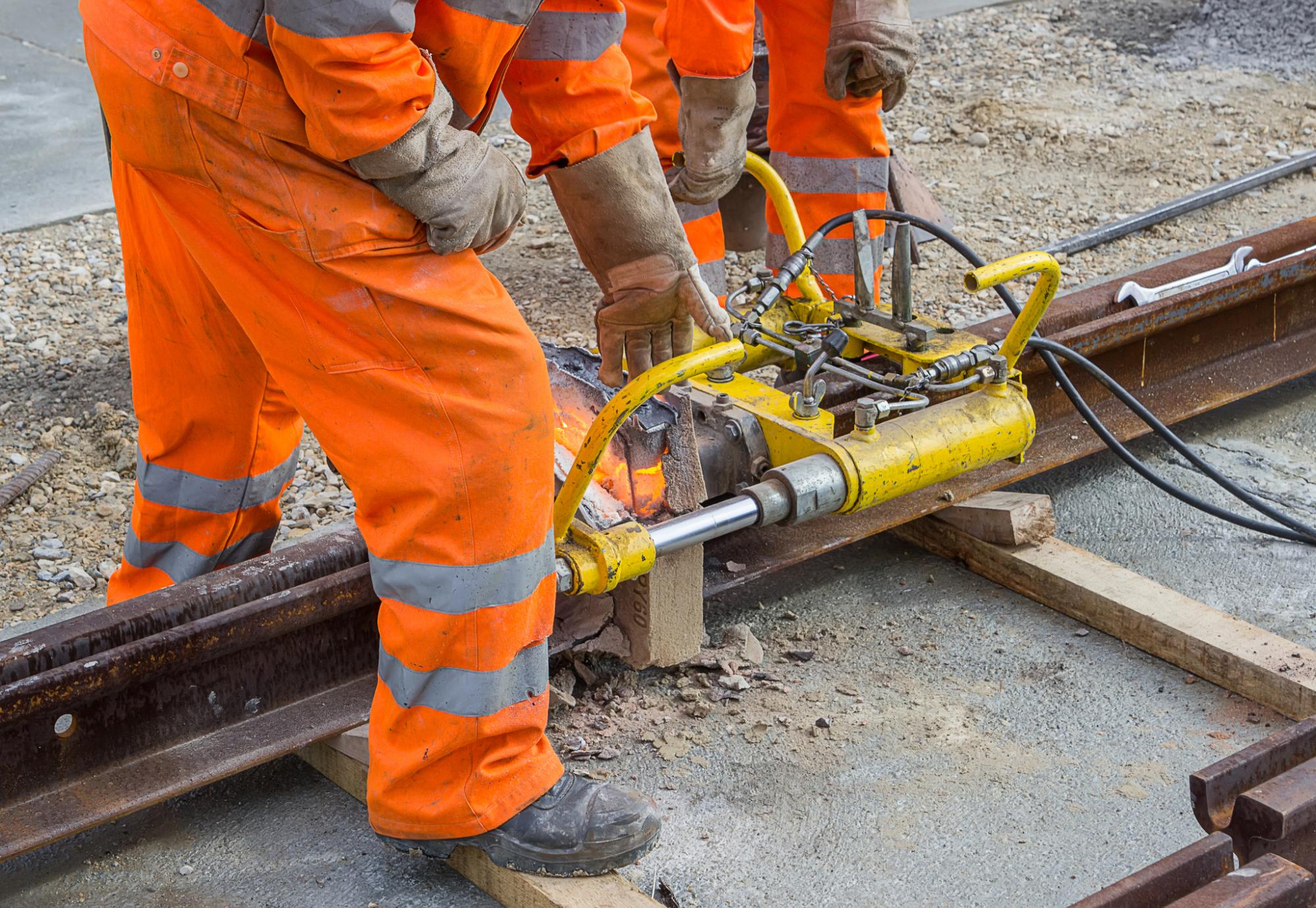 Weld trimmer being used by workers