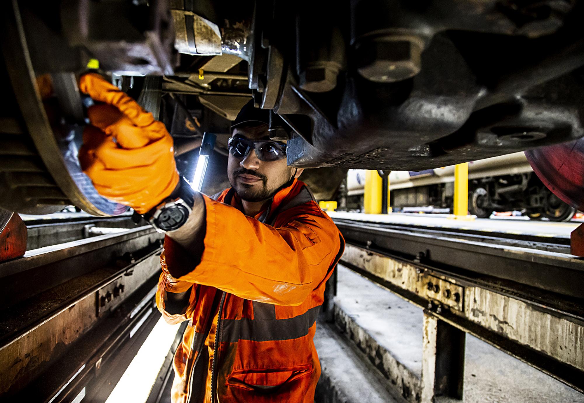 Engineer works on train