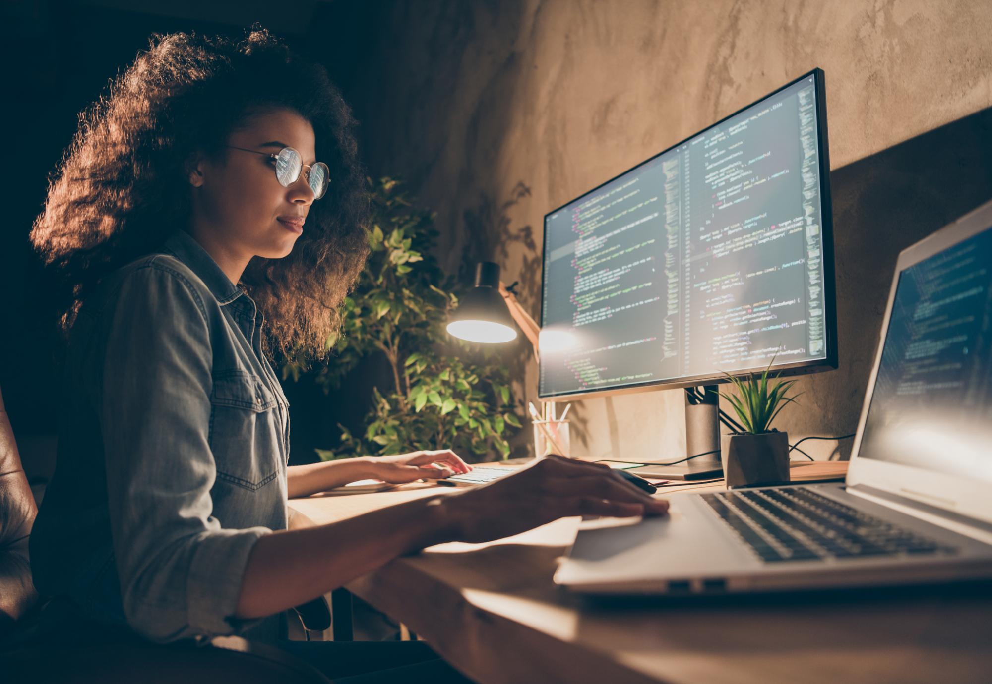 Young woman using a laptop to code