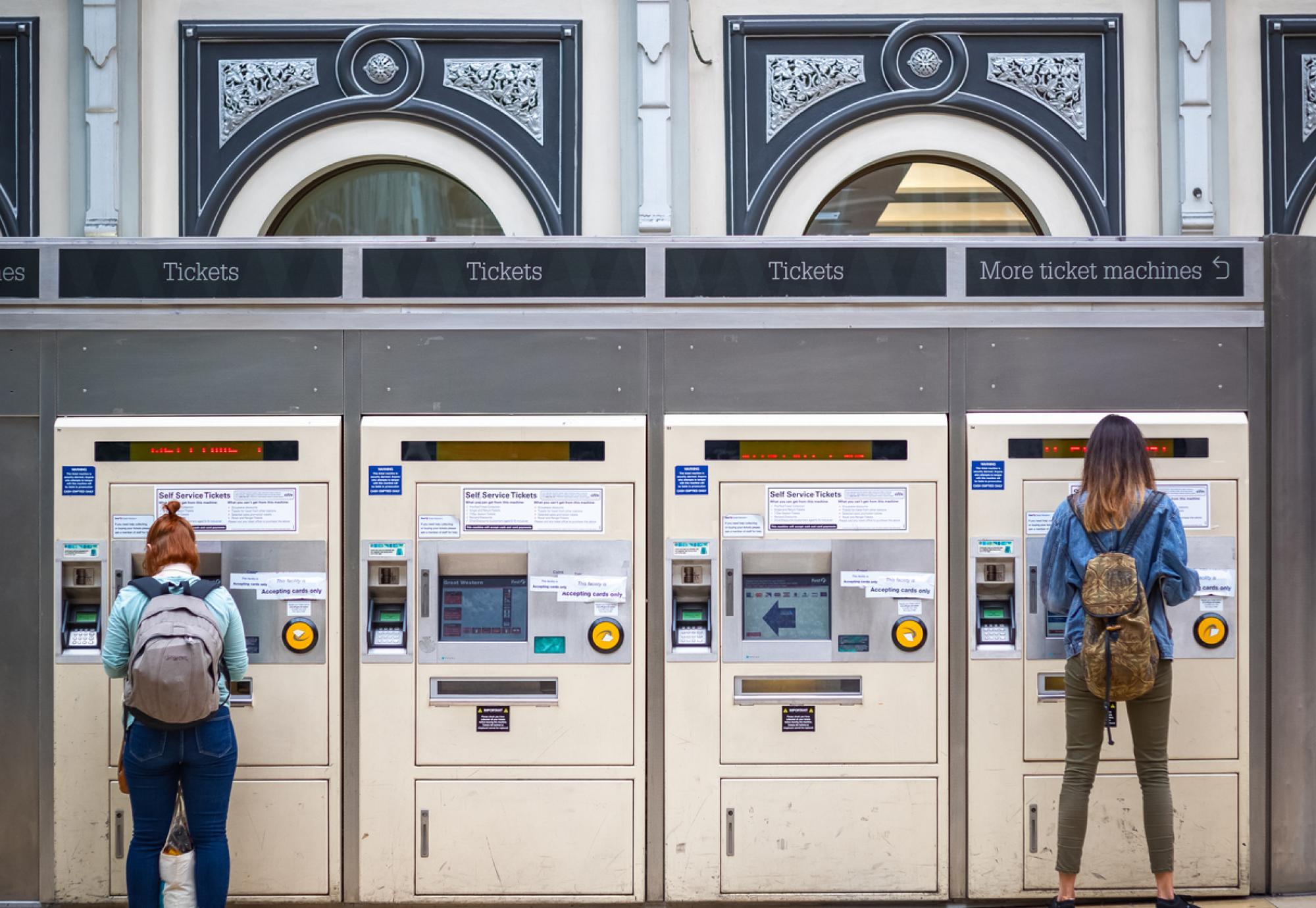 Passengers use ticket machines