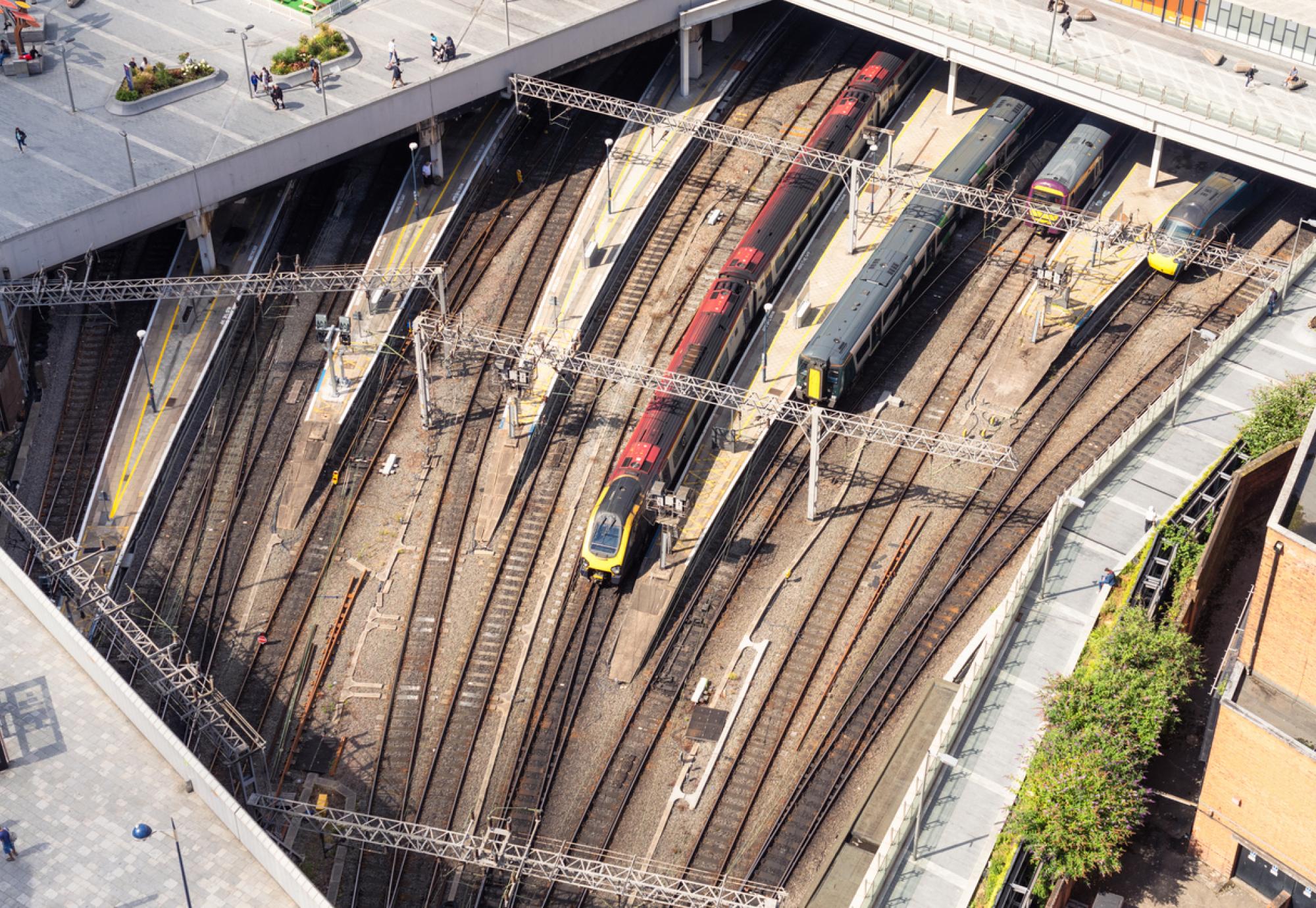 An aerial view of people walking on the pedestrianised paving above trains outside Birmingham's New Street station, in the city centre. Provided via Istock 