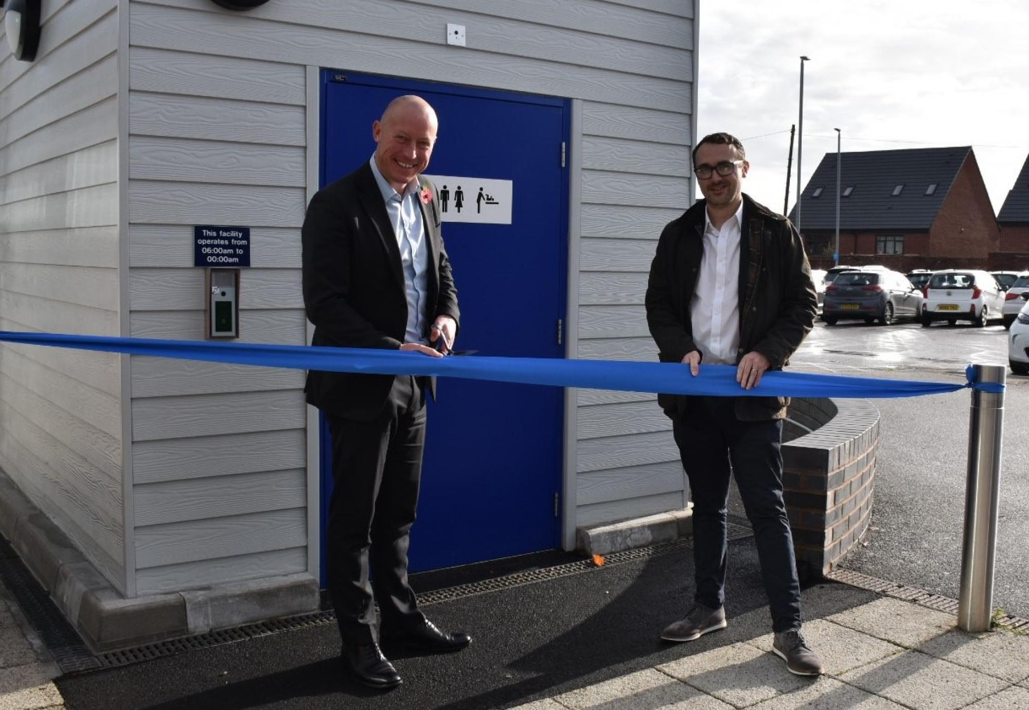 Chris Jackson and Simon Elliott open the new toilet pod by cutting a ribbon, via Northern