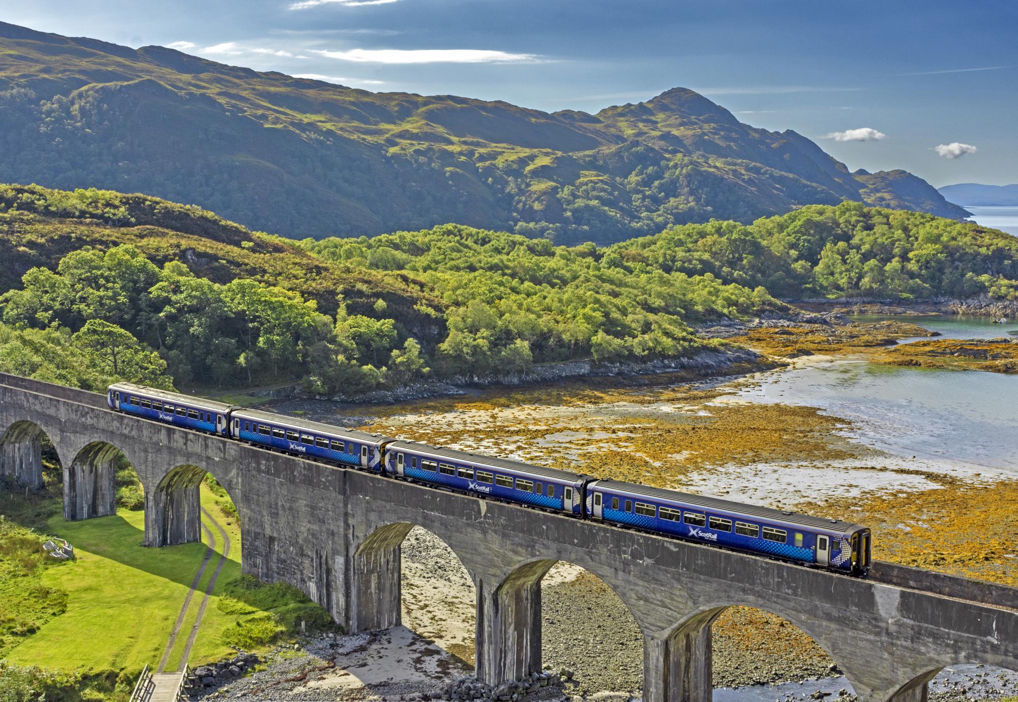 Scotrail train passing over the eight arch Nan Uamh Viaduct in late summer, via Istock 