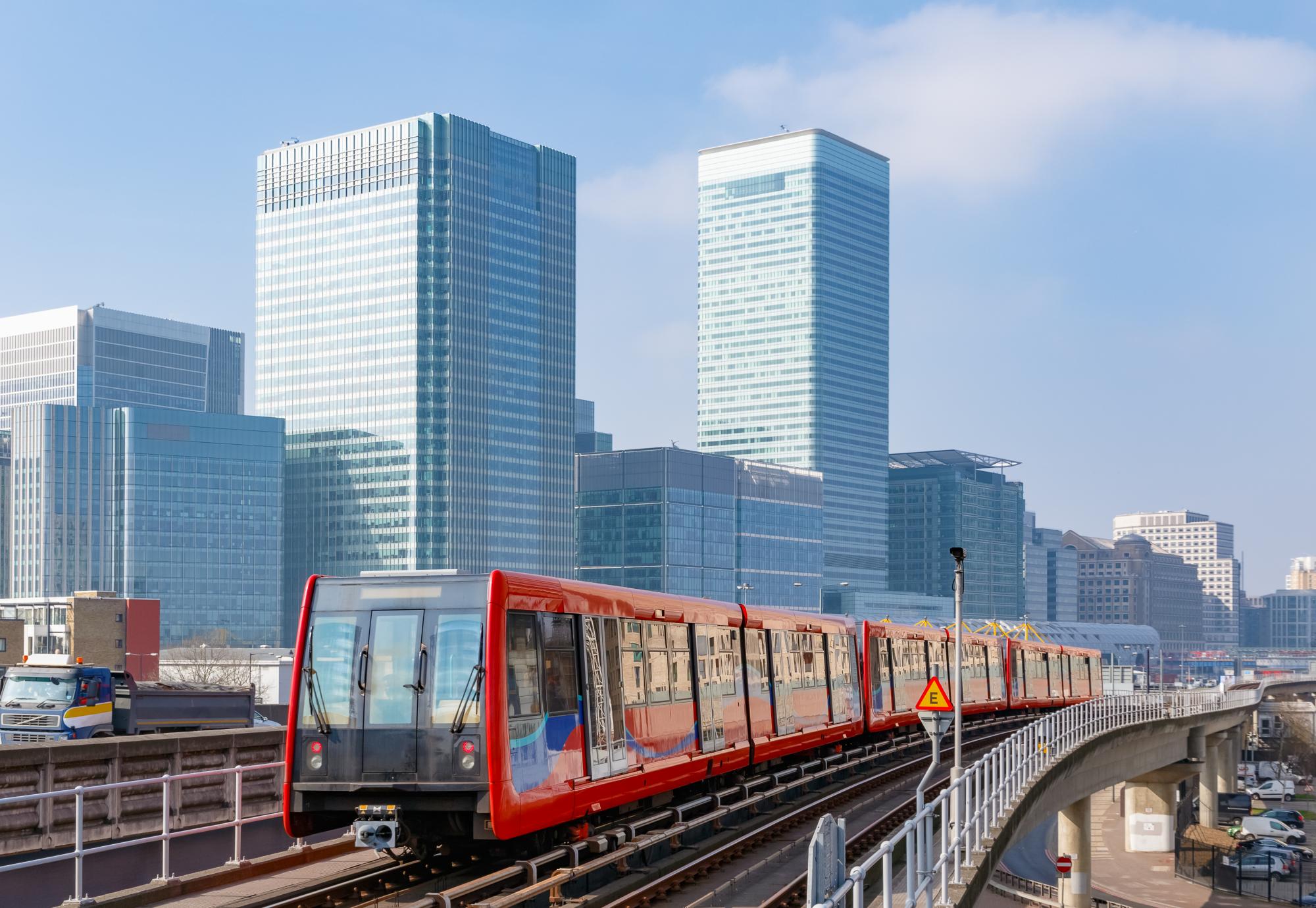 Docklands light railway in London with Canary Wharf in the background, via Istock 