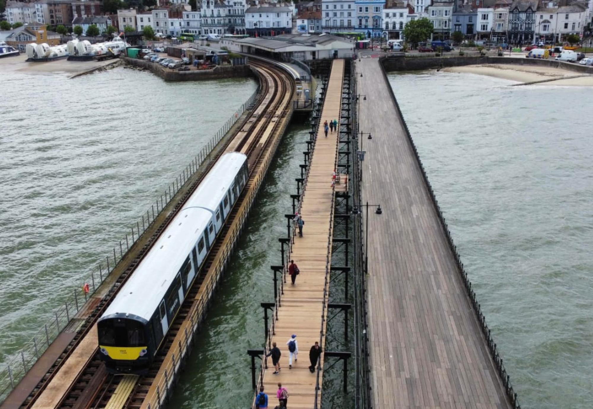 Aerial shot of a South Western Railway train running on the Ryde Pier on the Isle of Wight in July 2023