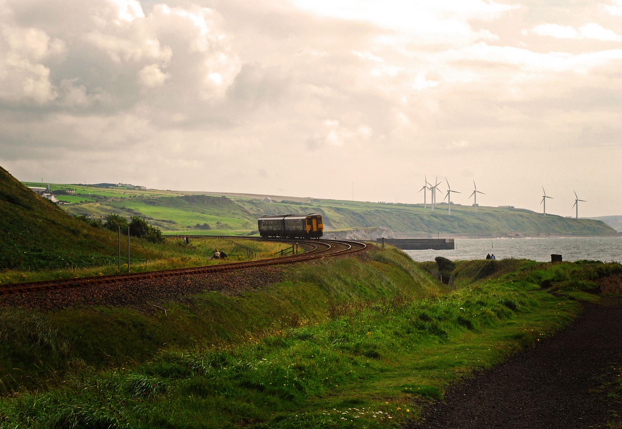 A railway carriage in front of a lake with a cloudy sky in the background, Whitehaven, Cumbria, England