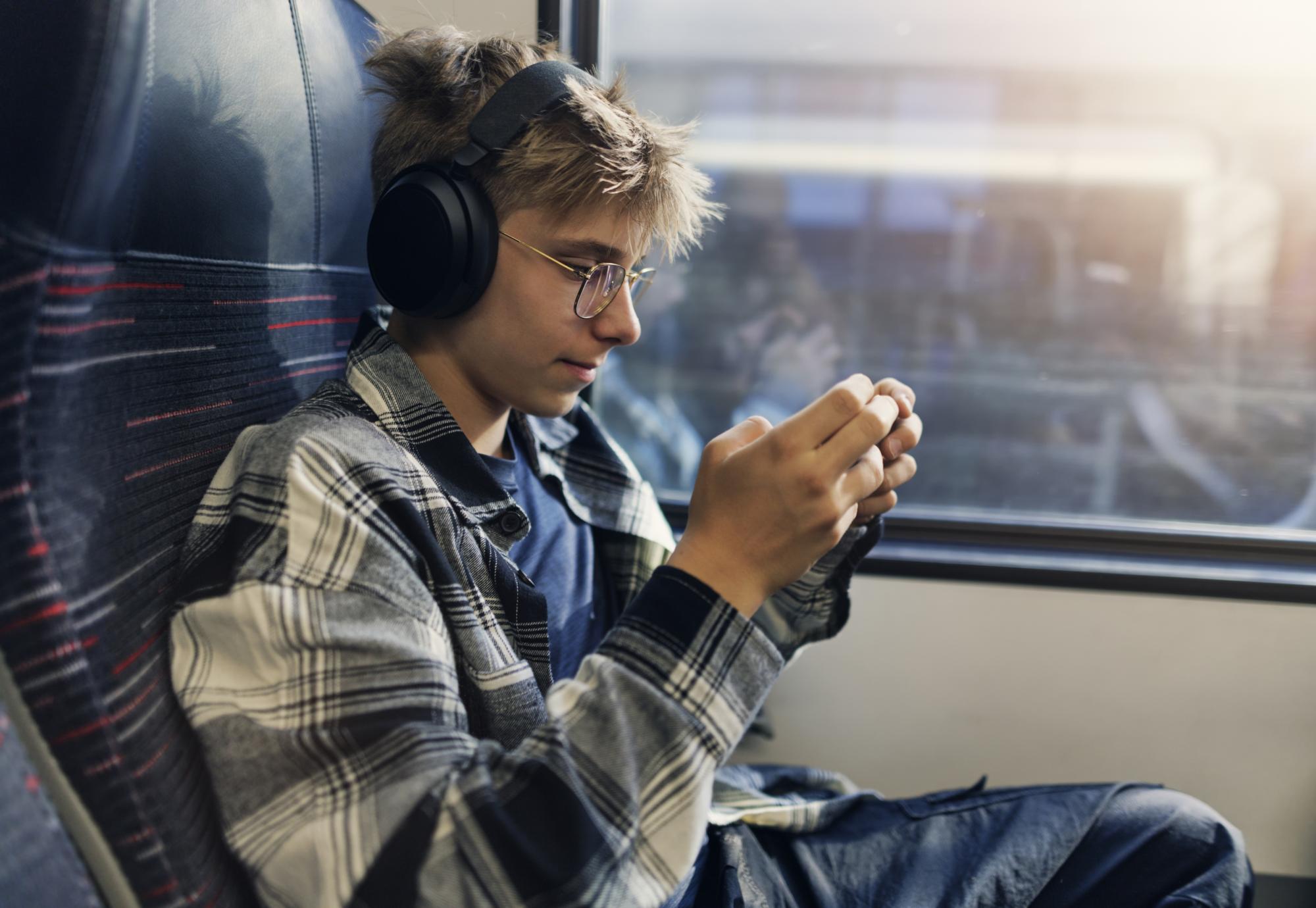 Teenage boy travelling by modern train