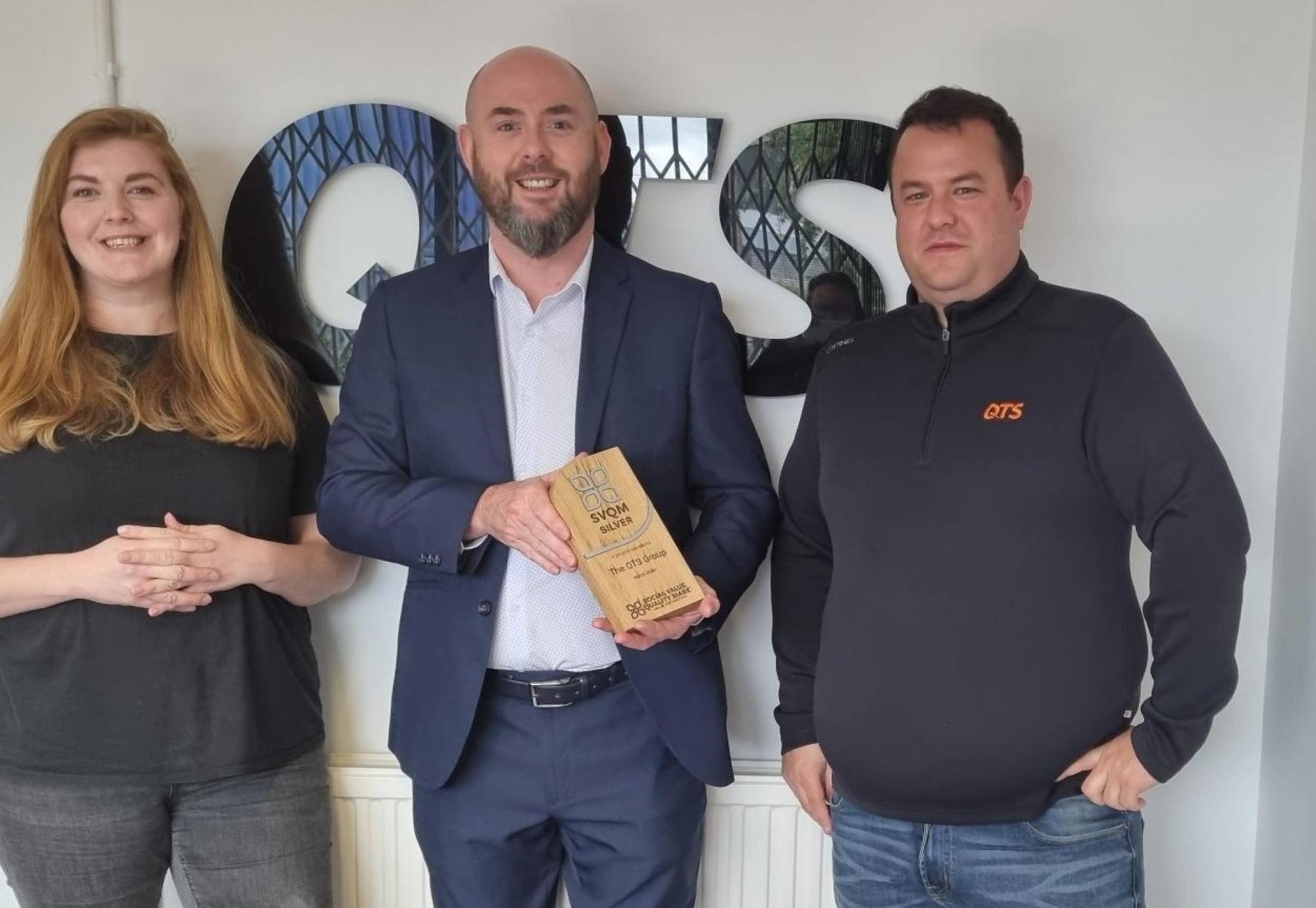 QTS staff with award