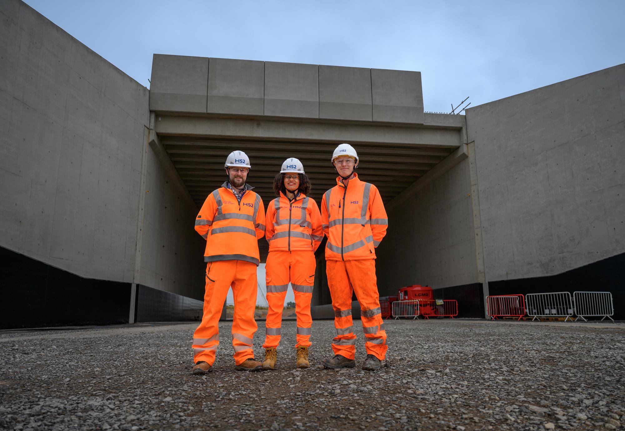 Picture of three HS2 workers stood in front of the new bridge