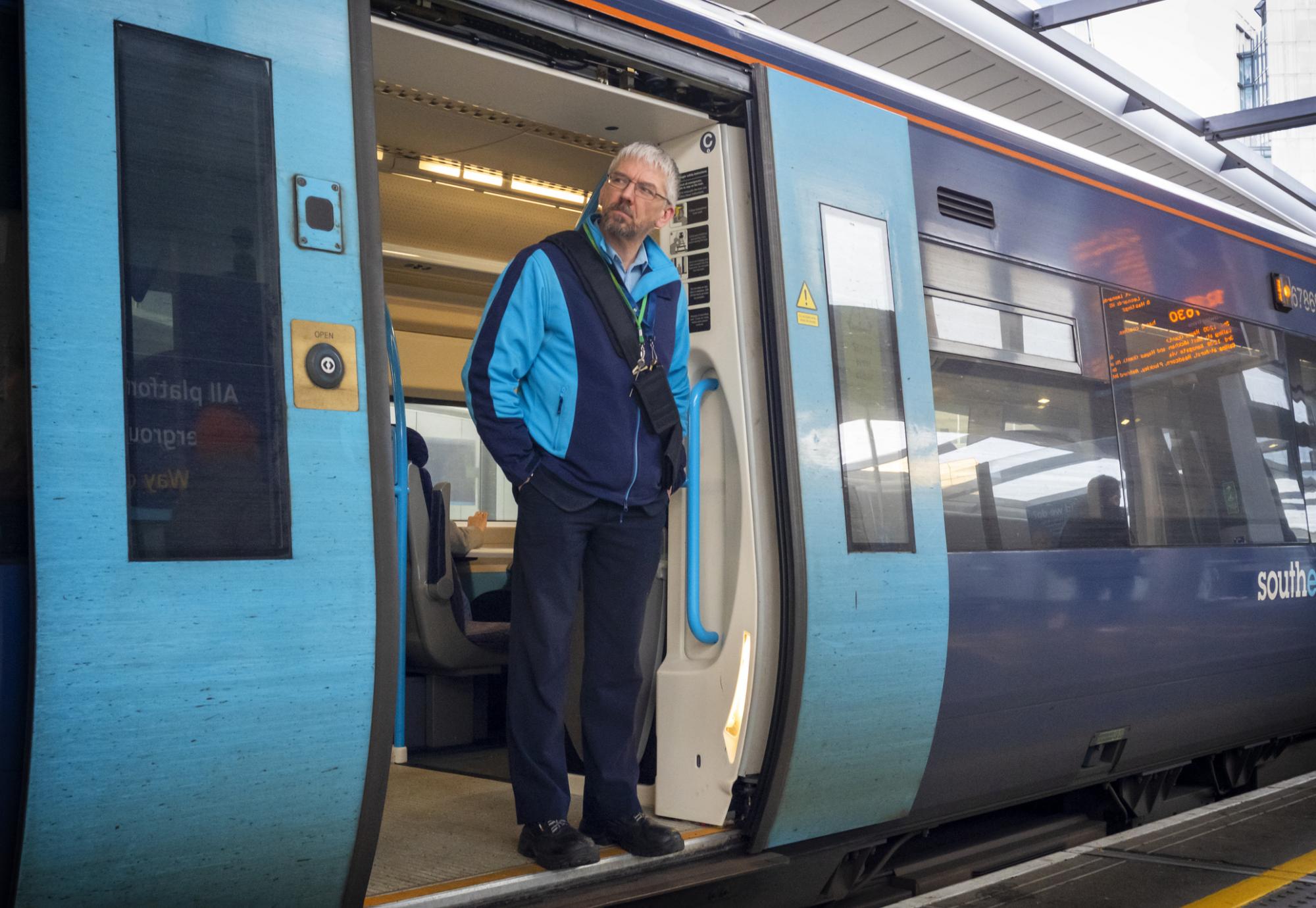 Train guard standing in the train door