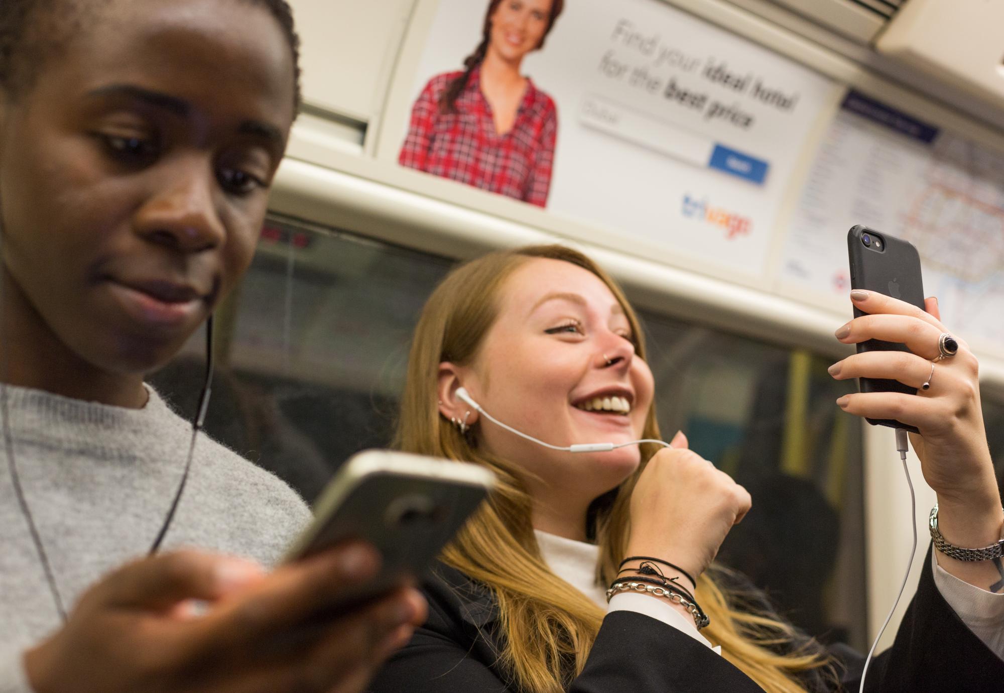 People using mobiles on the tube