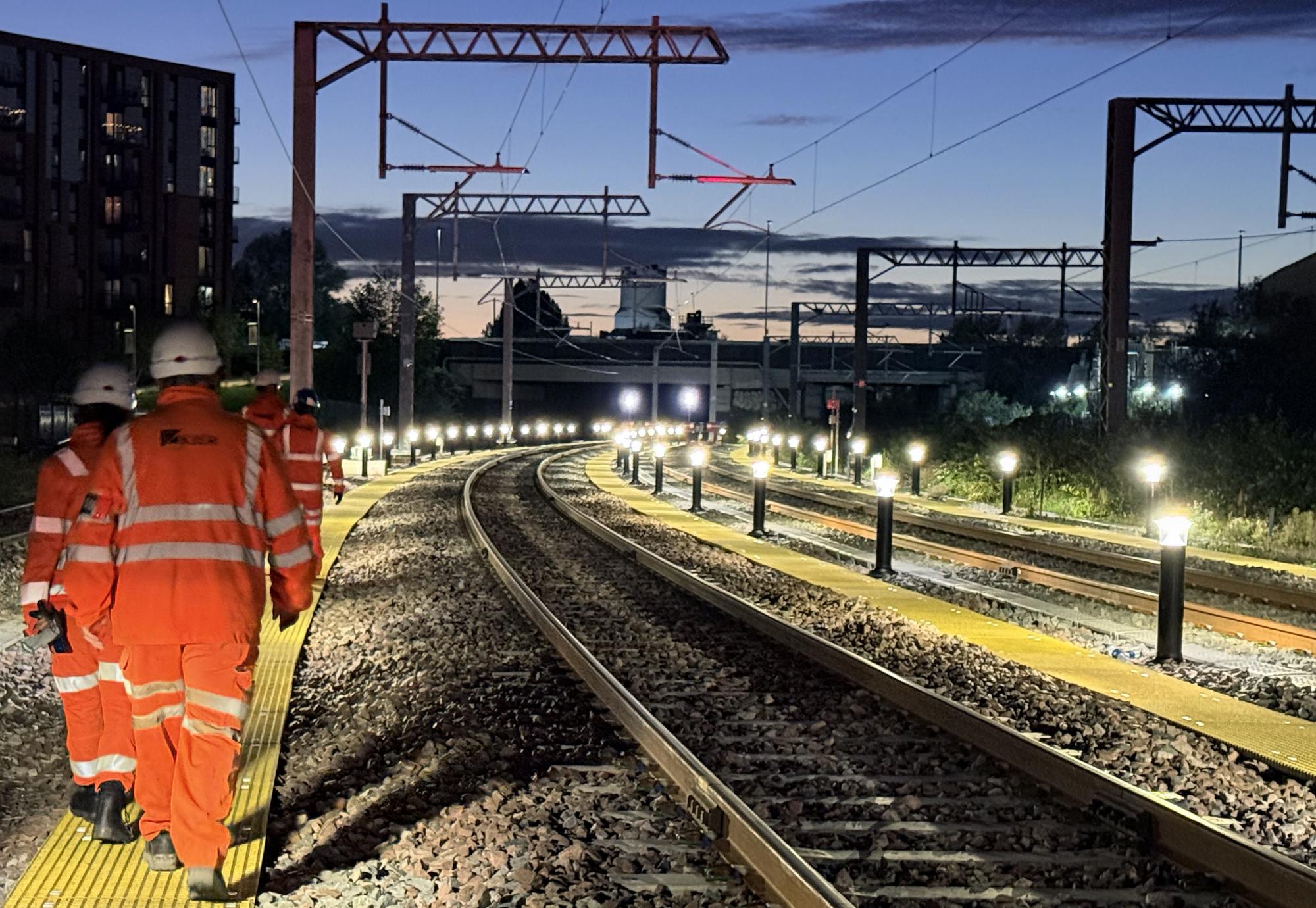 Workers inspecting new Oldfield Road turnback siding