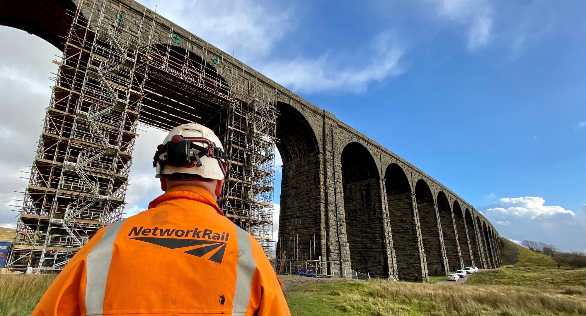 Ribblehead viaduct with a Network Rail worker in the foreground