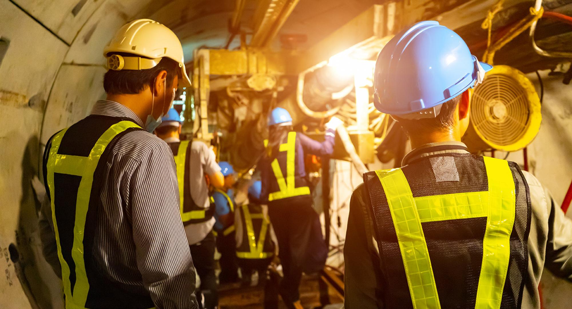 Engineers in a tunnel performing maintenance