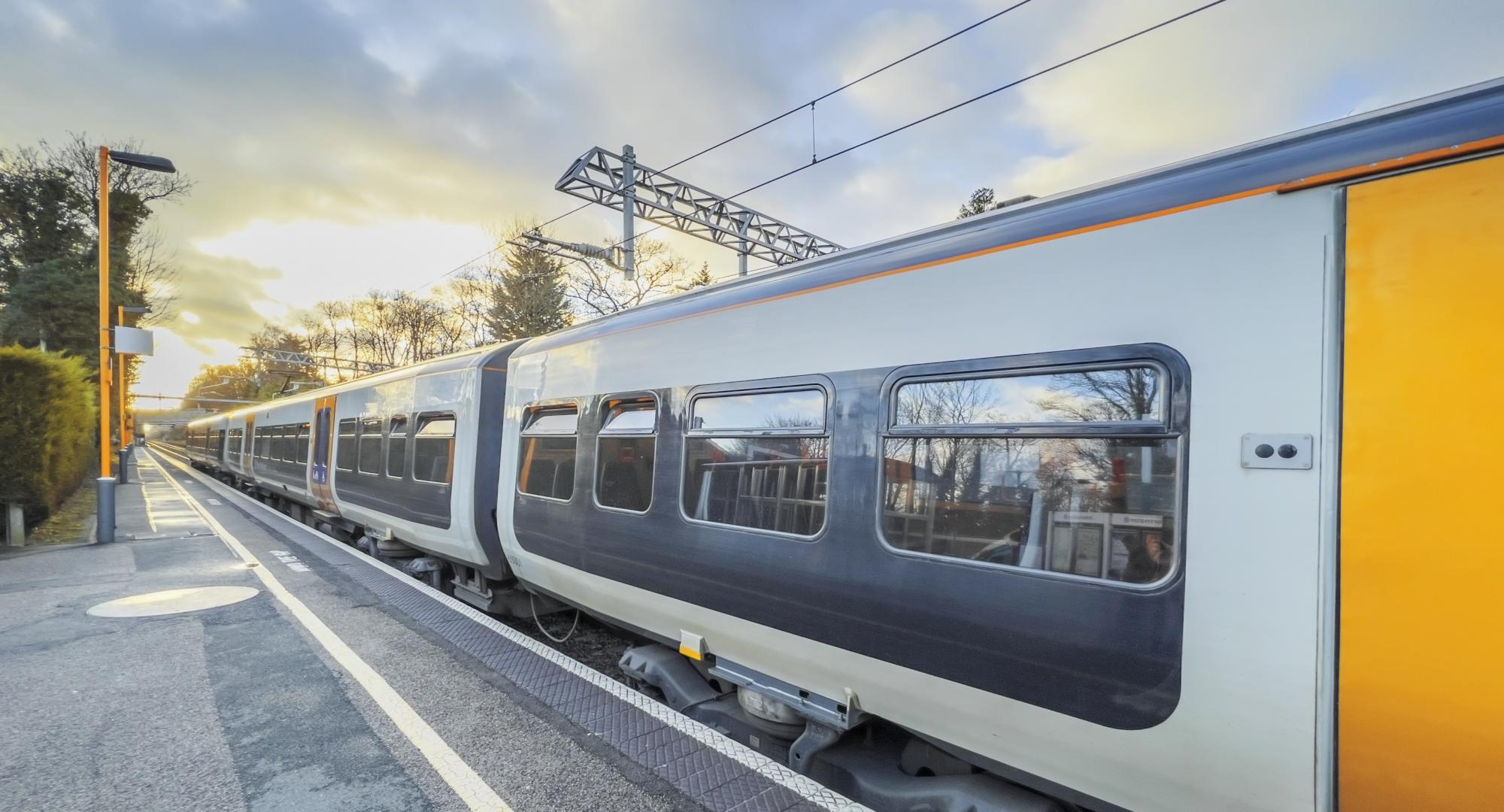 An electric powered train passes through the British Rail station, via Istock