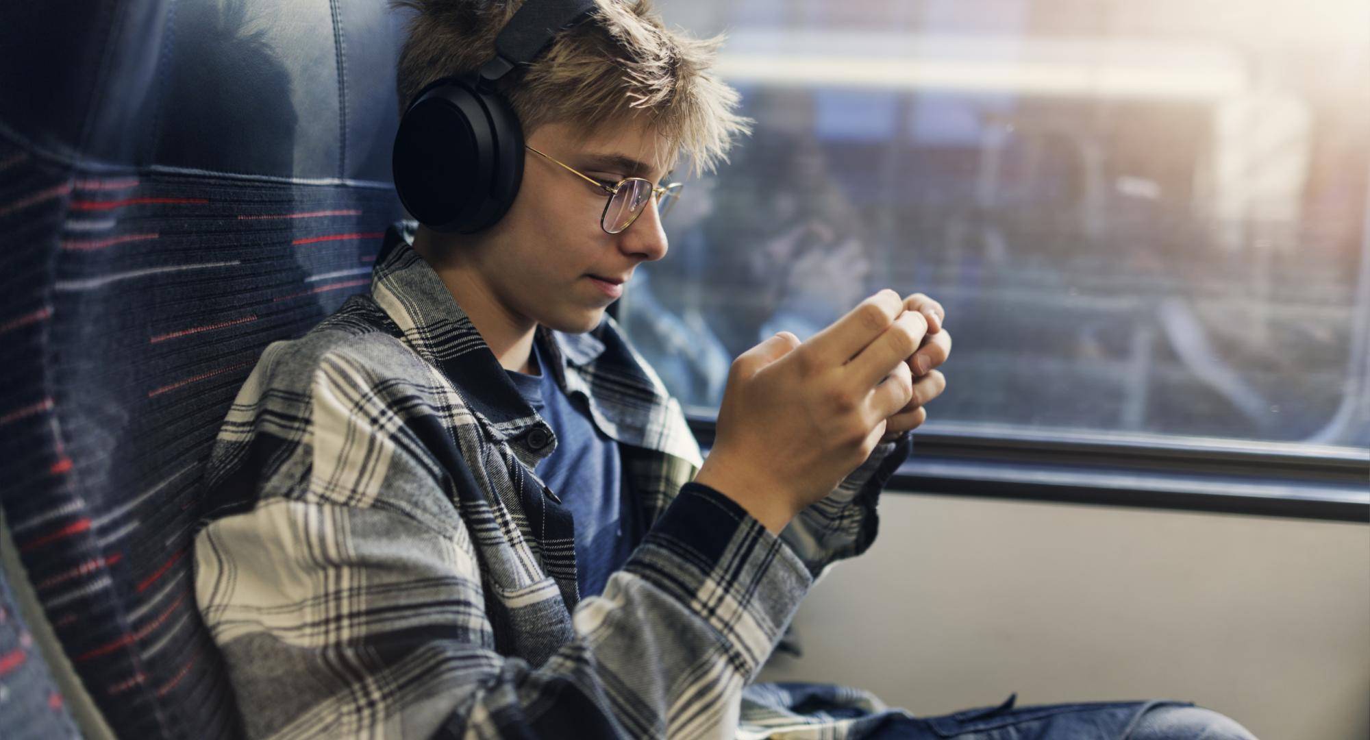 Teenage boy travelling by modern train