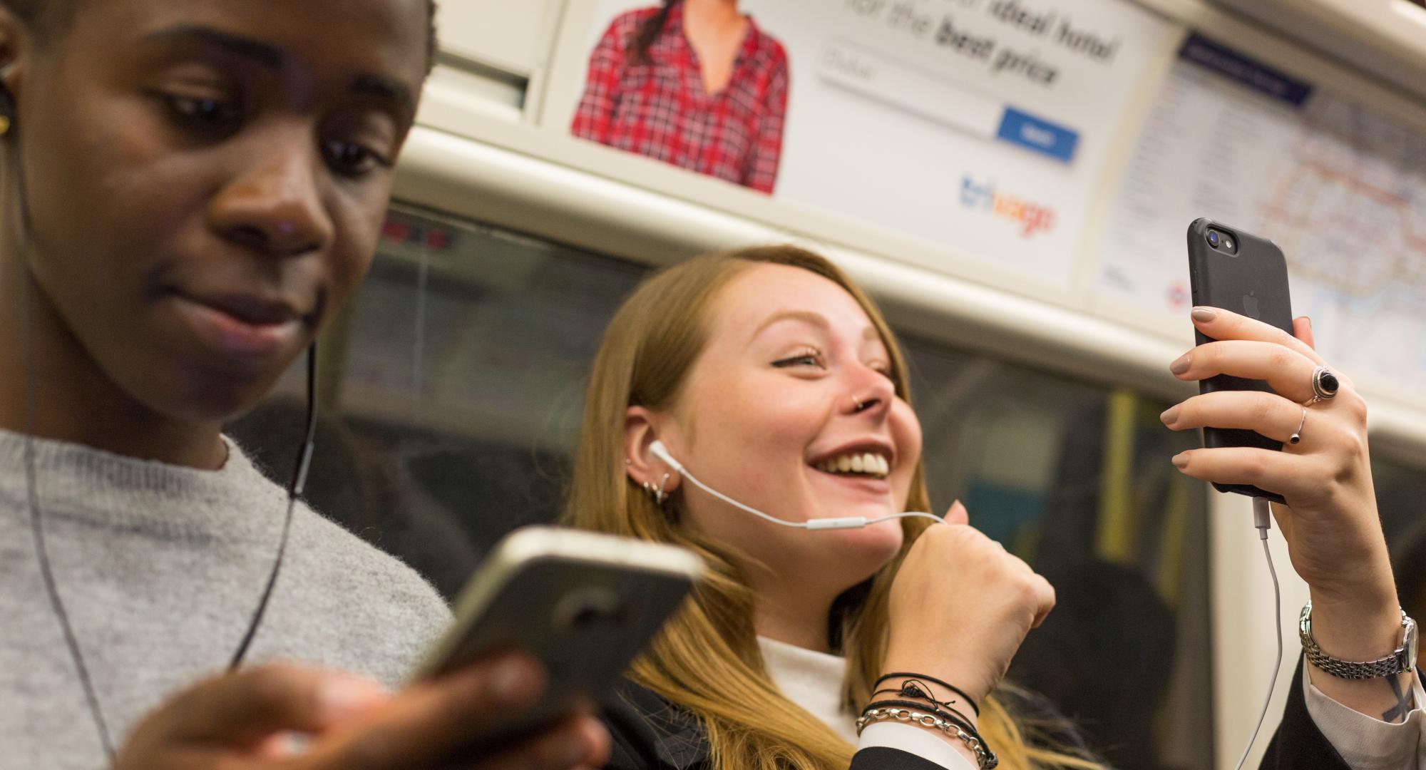 People using mobiles on the tube