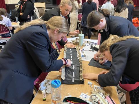Students at The Mount School constructing their bridge design at a Network Rail STEM day for International Women's Day 2