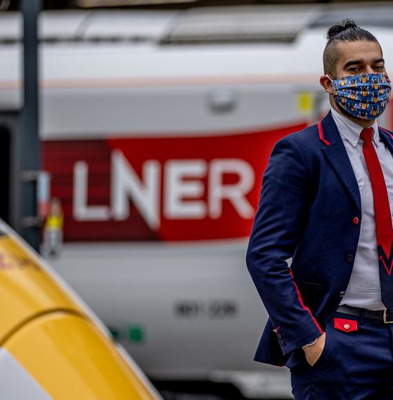 LNER Station Support Assistant Emrah Mehmet wearing the LNER Azuma Mask at London King’s Cross Station.