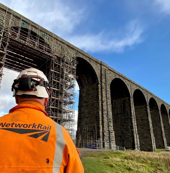 Ribblehead viaduct with a Network Rail worker in the foreground