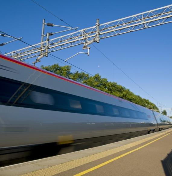 A British high speed passenger train passing through a station in the early morning