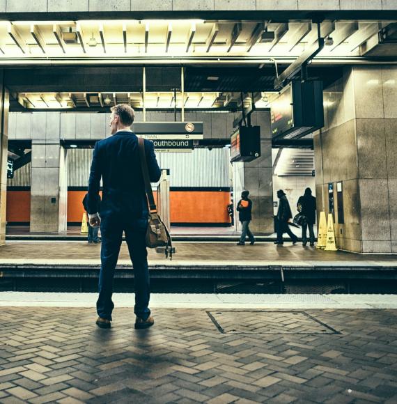 Businessman waiting at a train platform