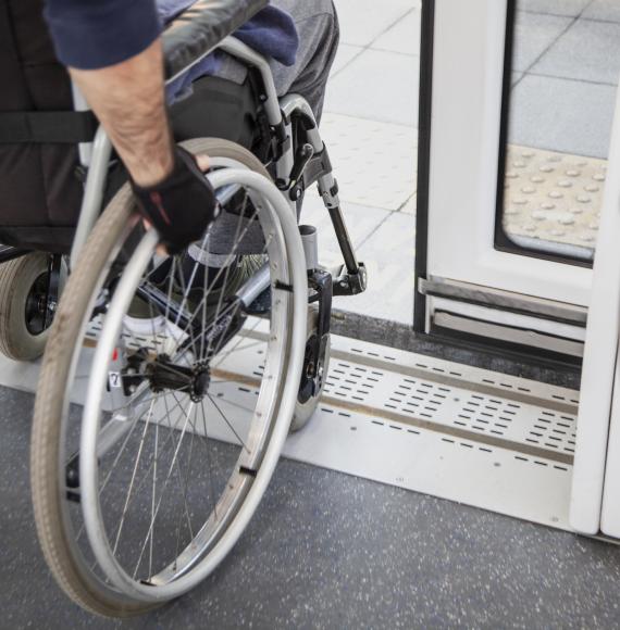 Passenger in a wheelchair disembarking from a train