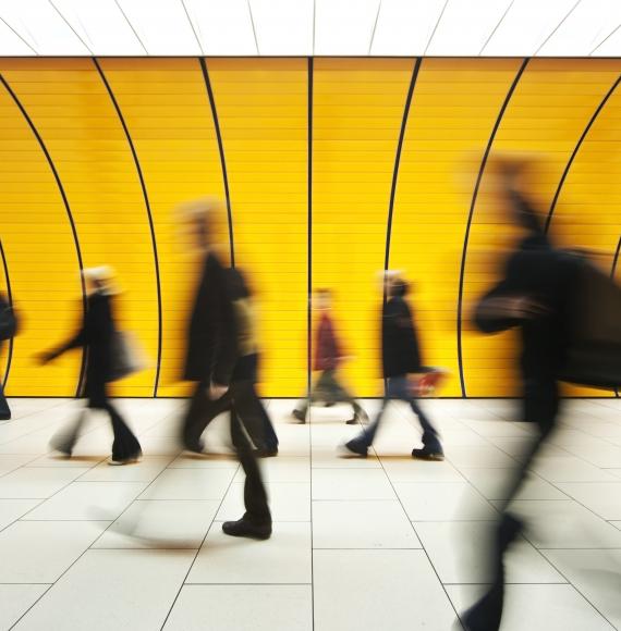 Commuters wlaking past on a train platform