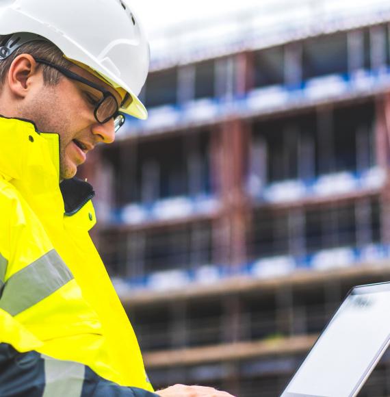 Industrial engineer looking at plans on site